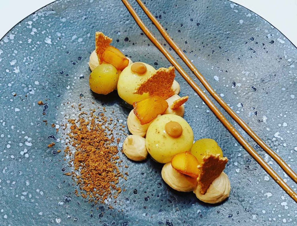 Yellow dish on black board at Coperto Restobar in Zwolle
