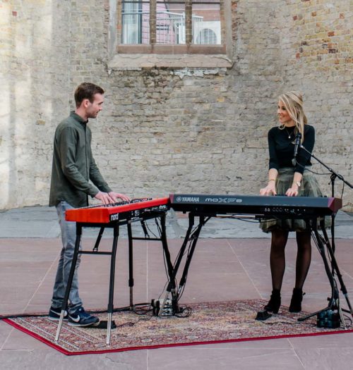 Man and woman playing keyboard