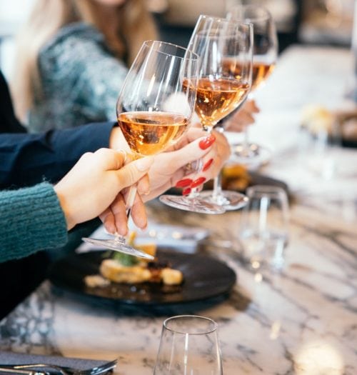 People toast wine on a marble table at Coperto Restobar in Zwolle