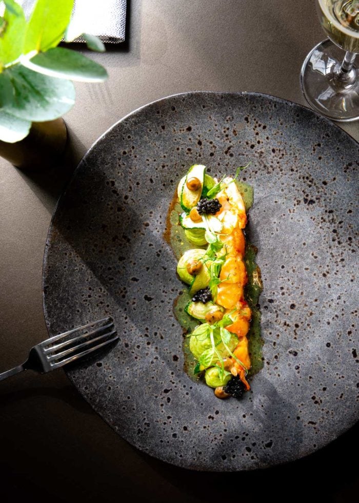 Lobster dish on a black plate at Coperto Restobar in Zwolle